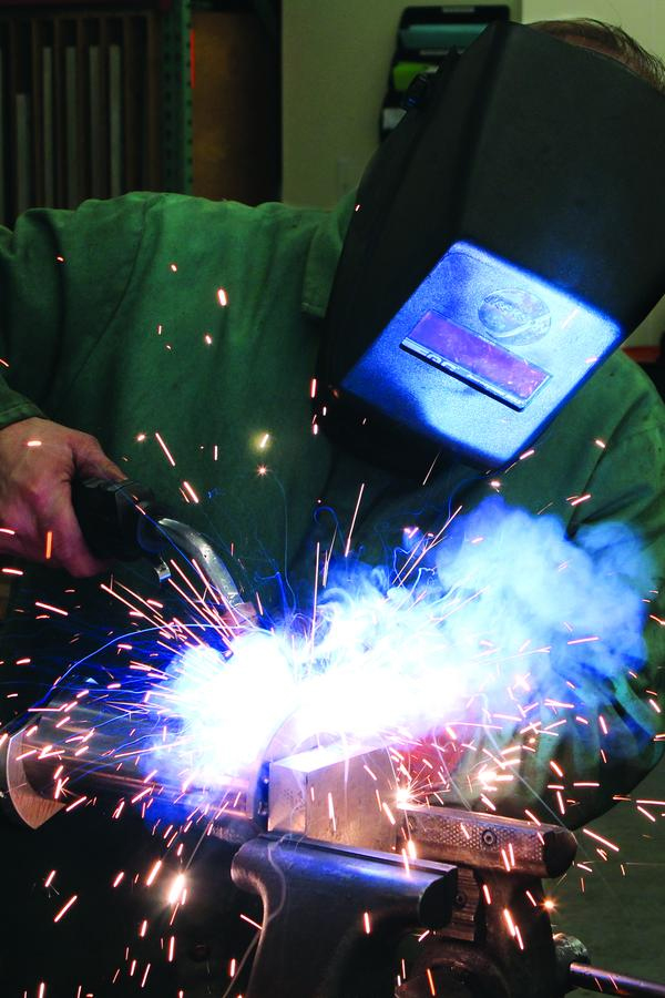 Kevin Ray welds a component to be used with a plunger mechanism manufactured by Quantum Engineered Products, Inc. in Saxonburg.